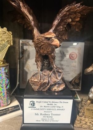 A bronze eagle award on a black base, presented to Rodney Toomer for community service